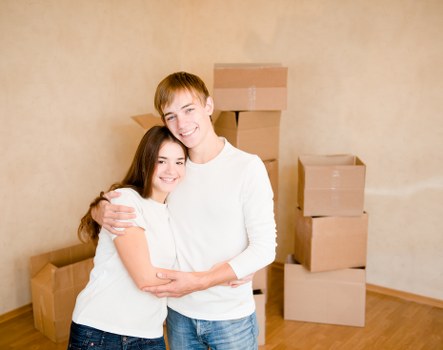 Packed moving boxes and furniture ready for transport in a local home
