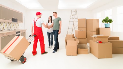 Packed moving boxes and furniture being loaded into a van