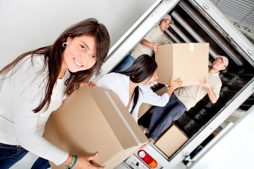Moving team unloading boxes at a property in Richmond upon Thames